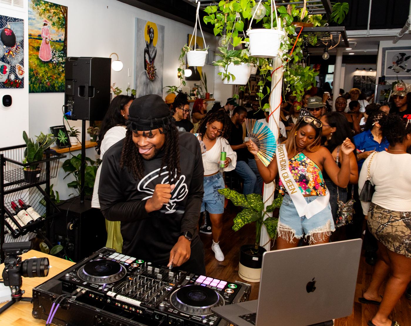 DJ Sole at the decks while a crowd dances at a birthday party