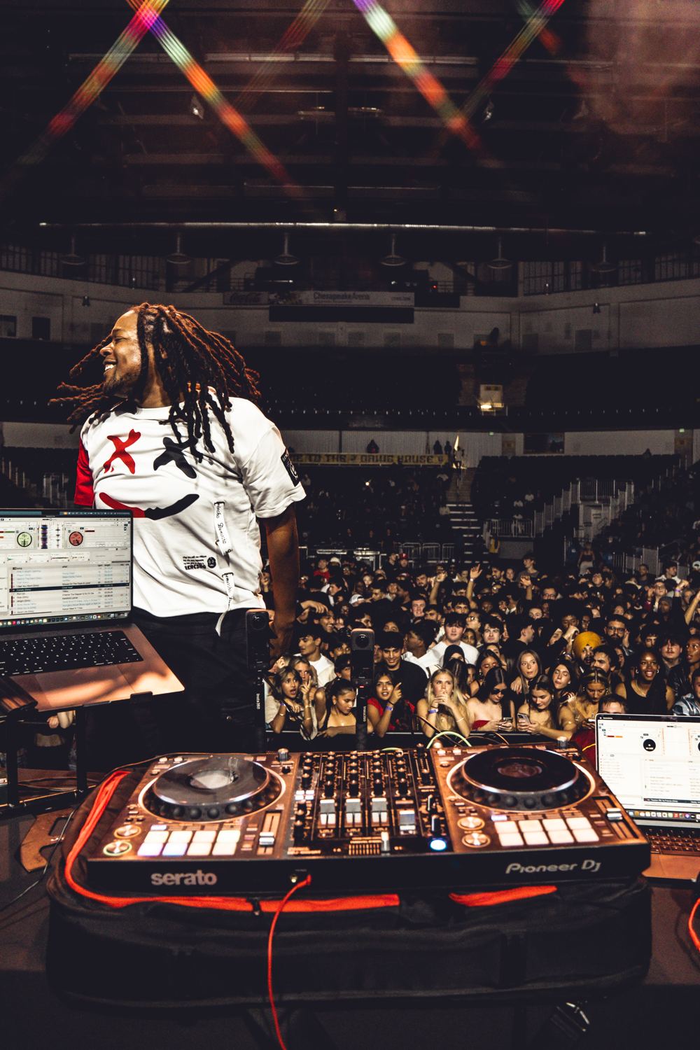 DJ Sole on stage over a packed concert crowd