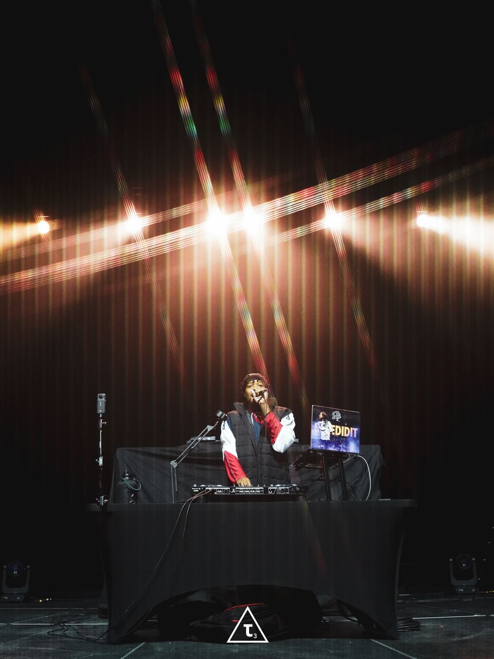 DJ Sole performing on stage under spotlights
